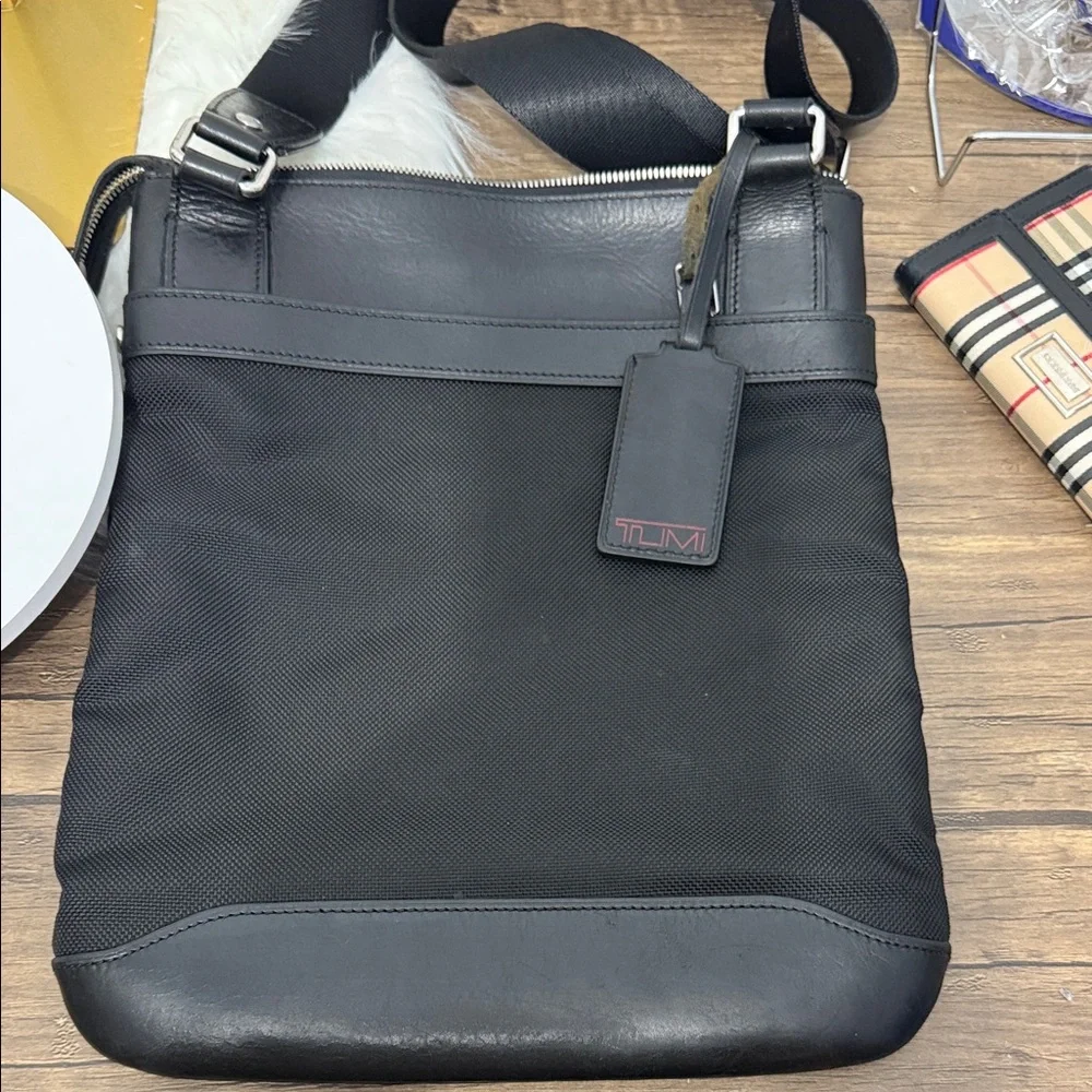 Tumi Black Messenger Bag with Silver Accents. Excellent condition